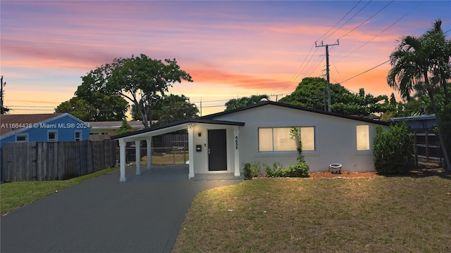 single story home with a yard and a carport