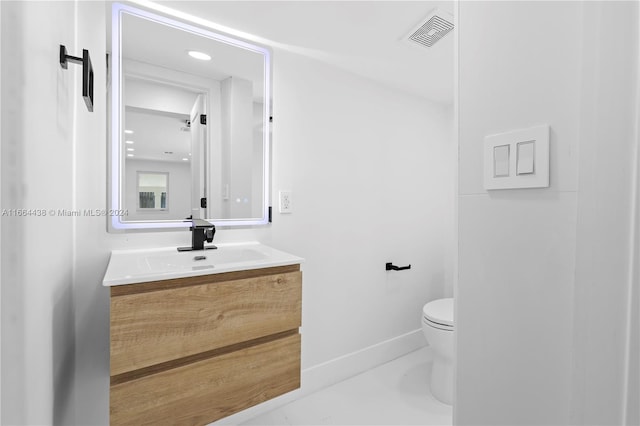 bathroom featuring vanity and toilet