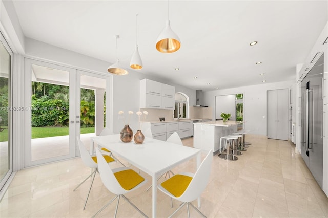 dining room with french doors, light tile patterned floors, and sink