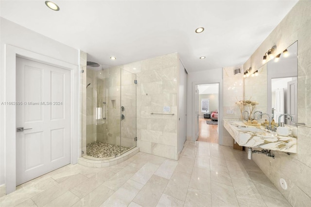 bathroom with walk in shower and tile walls