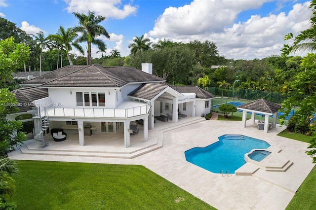 back of property with a lawn, a patio, and a gazebo