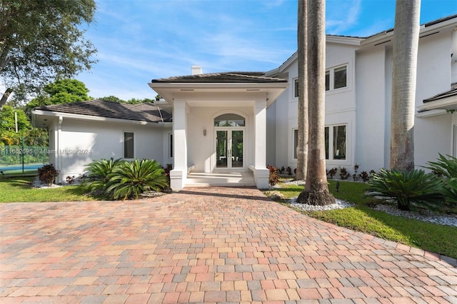 view of exterior entry featuring french doors