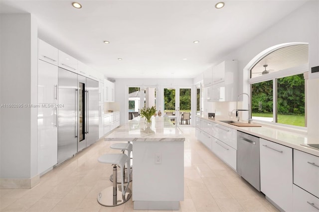 kitchen featuring white cabinets, a wealth of natural light, and appliances with stainless steel finishes