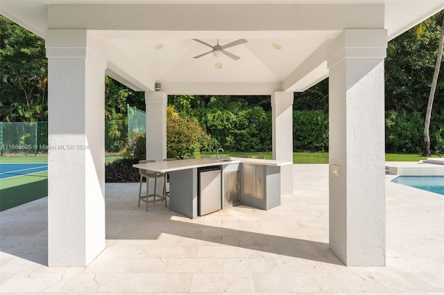 view of patio featuring ceiling fan and a gazebo