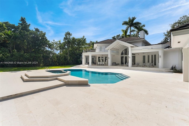 view of swimming pool featuring a patio and an in ground hot tub