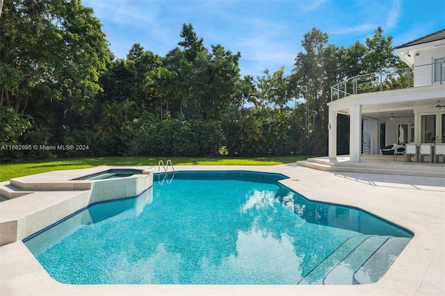 view of pool featuring a patio area, ceiling fan, and an in ground hot tub