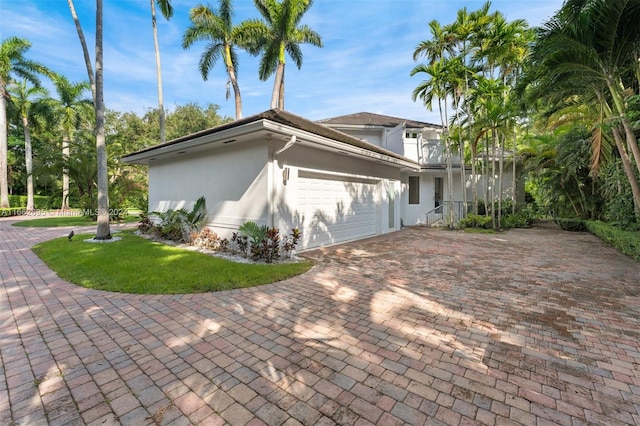 view of home's exterior featuring a garage and a yard