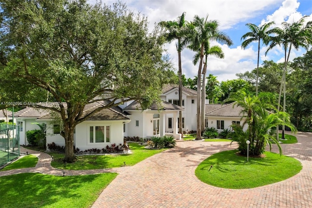 mediterranean / spanish house with a front lawn