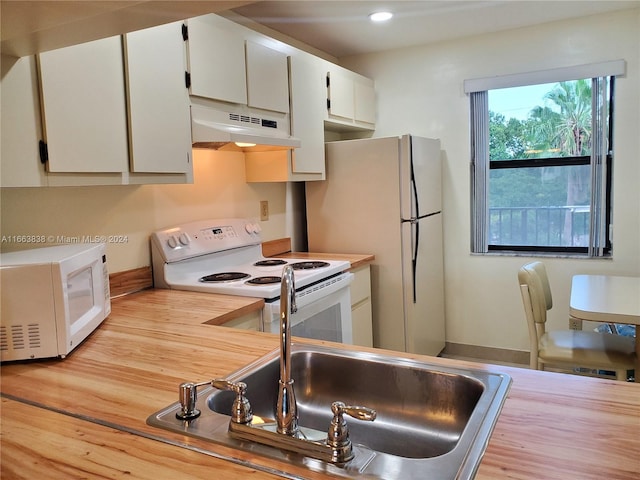 kitchen featuring white appliances, light hardwood / wood-style floors, white cabinetry, and sink