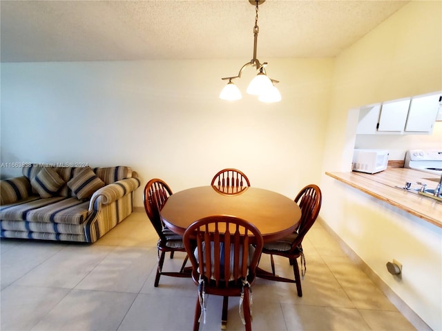 dining space featuring a textured ceiling and an inviting chandelier