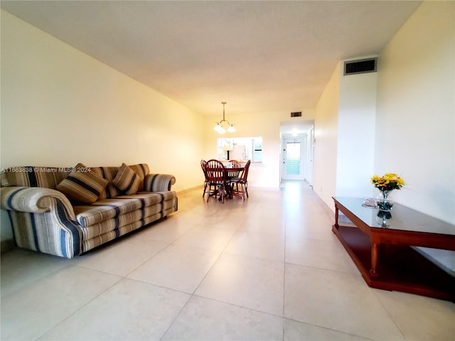 tiled living room with a notable chandelier