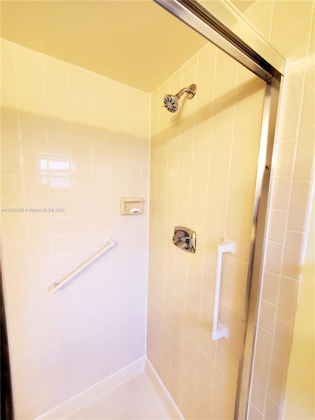 bathroom featuring a shower with door