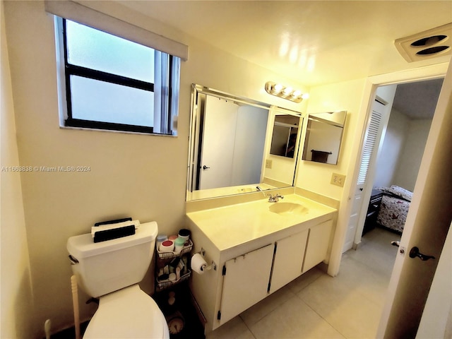 bathroom featuring vanity, toilet, and tile patterned floors