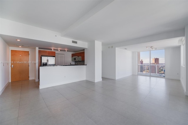 unfurnished living room featuring light tile patterned floors