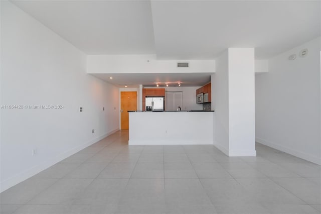 unfurnished living room featuring light tile patterned flooring