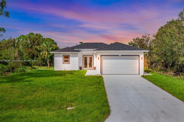 view of front of home featuring a lawn and a garage