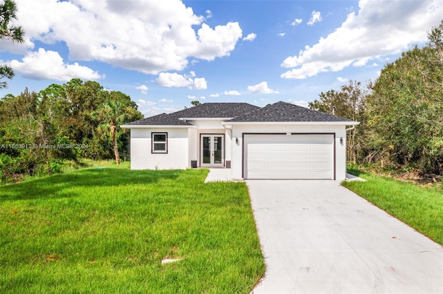 view of front of property with a front yard and a garage