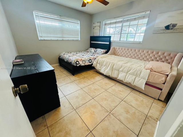 bedroom featuring light tile patterned floors and ceiling fan