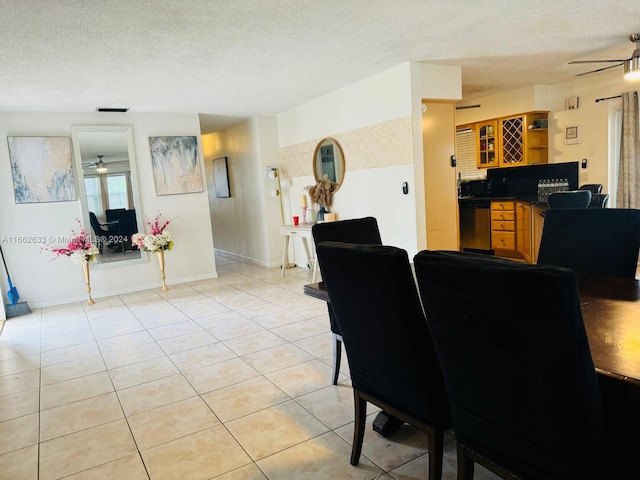 dining area with ceiling fan, a textured ceiling, and light tile patterned floors