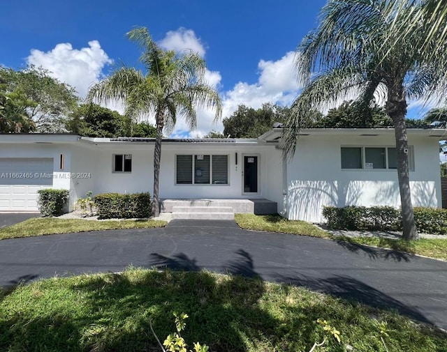 single story home featuring a garage