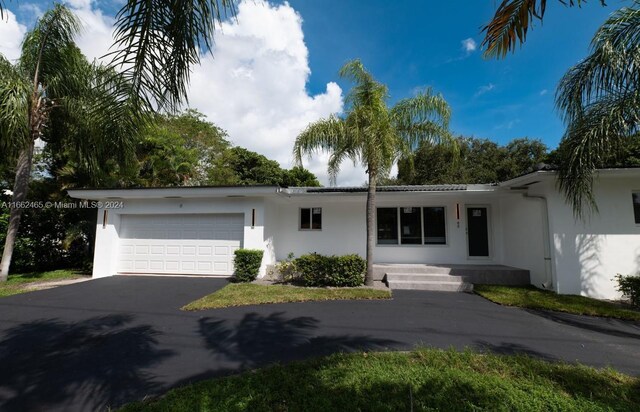 ranch-style home featuring a garage