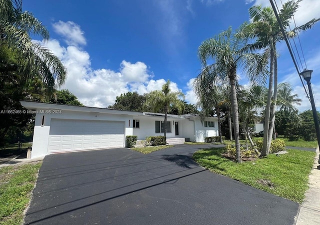 ranch-style home with a front yard and a garage