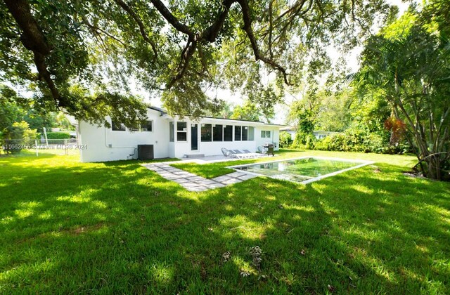 view of yard featuring central AC and a patio area