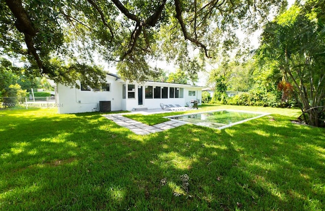 view of yard featuring a patio and central AC unit