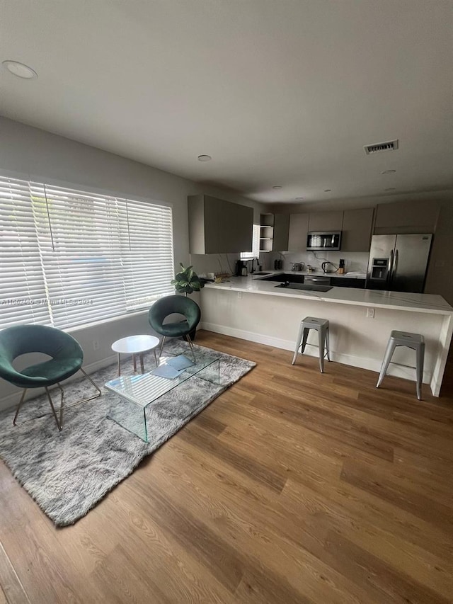 living room featuring light hardwood / wood-style floors and sink