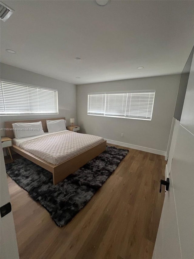 bedroom with wood-type flooring