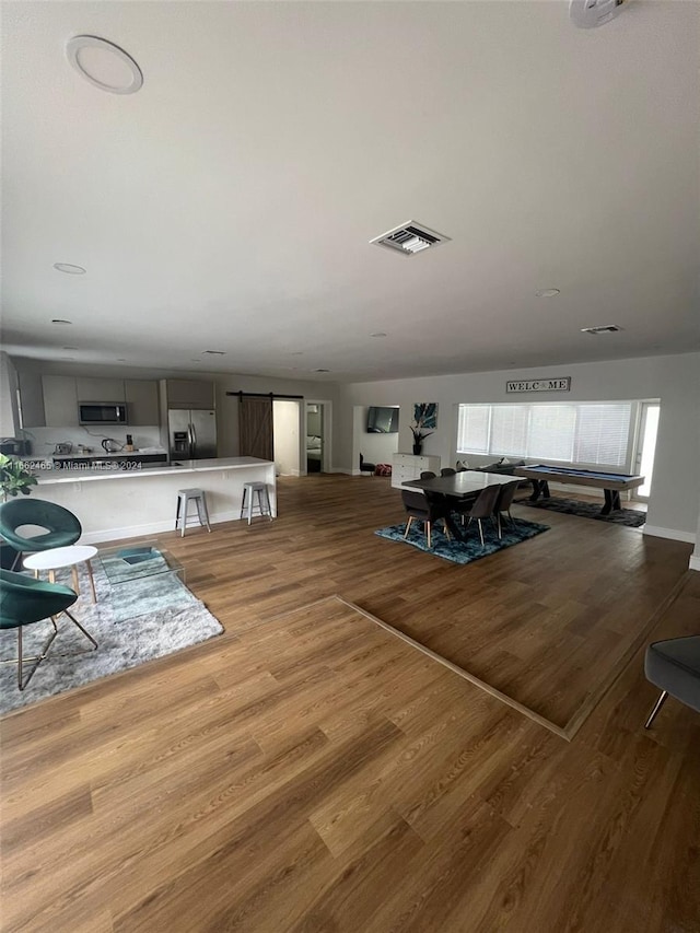 dining room with light hardwood / wood-style flooring and vaulted ceiling