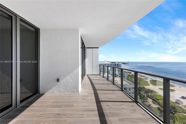 balcony with a beach view and a water view