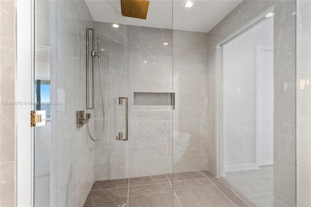 bathroom featuring a shower with shower door