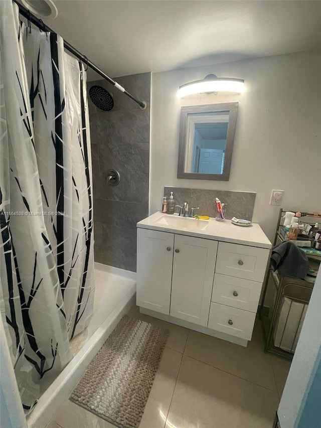 bathroom featuring tile patterned flooring, a shower with curtain, and vanity