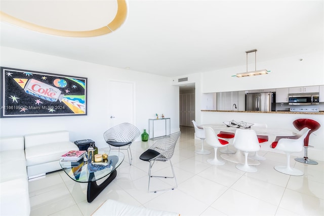 living room with sink and light tile patterned floors