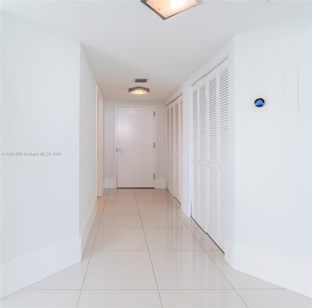 corridor with light tile patterned flooring