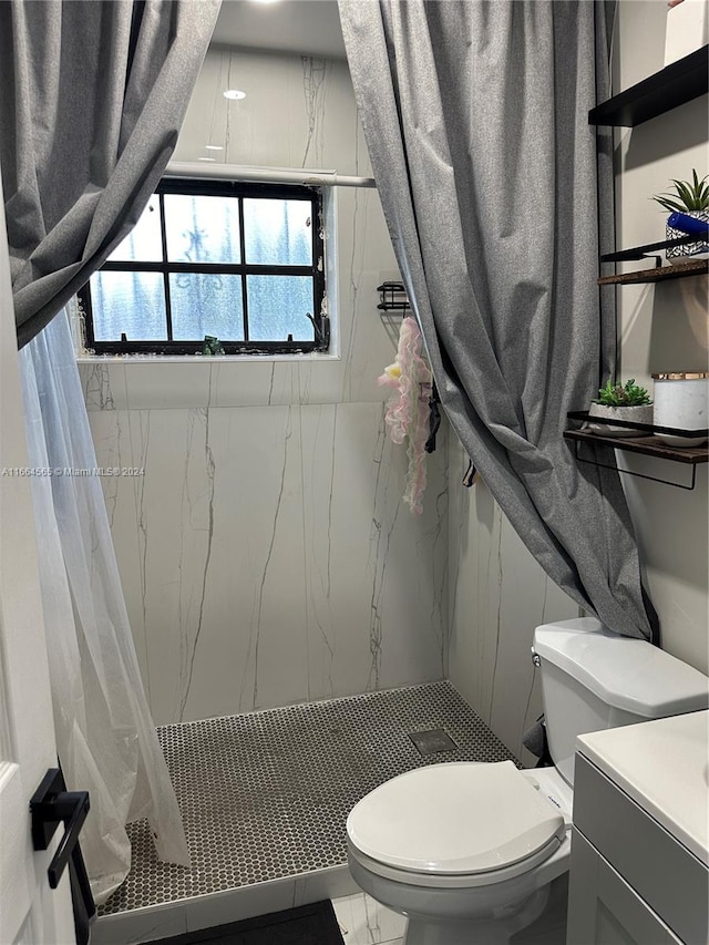 bathroom with vanity, toilet, and curtained shower