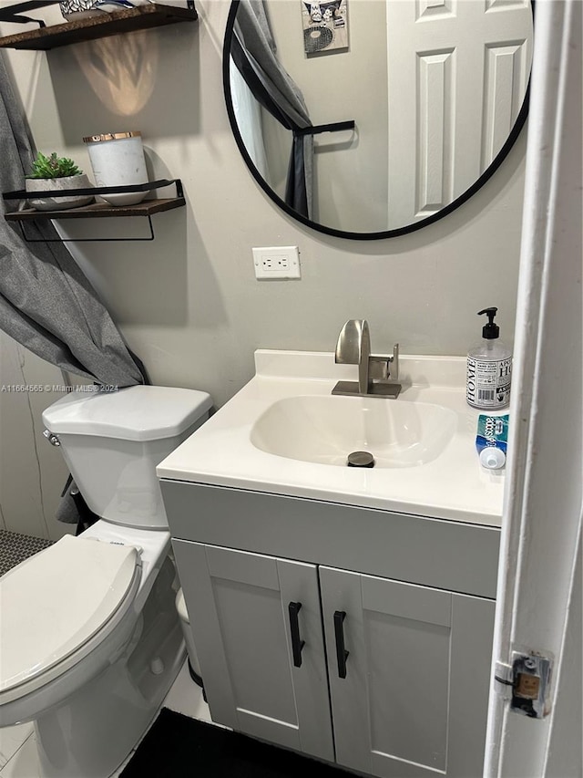 bathroom featuring vanity and toilet