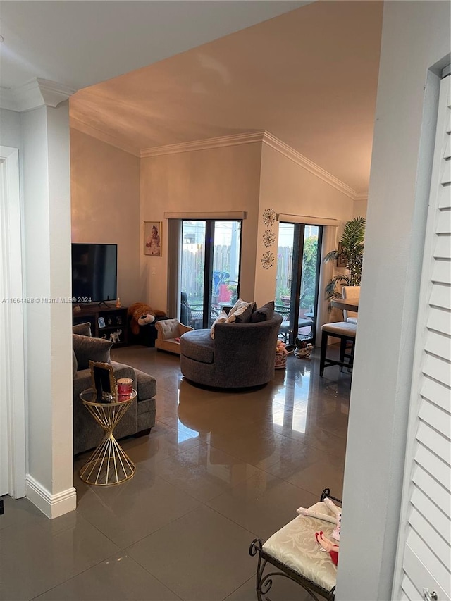 tiled living room featuring ornamental molding, vaulted ceiling, and french doors