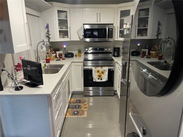 kitchen with white cabinetry, appliances with stainless steel finishes, and sink