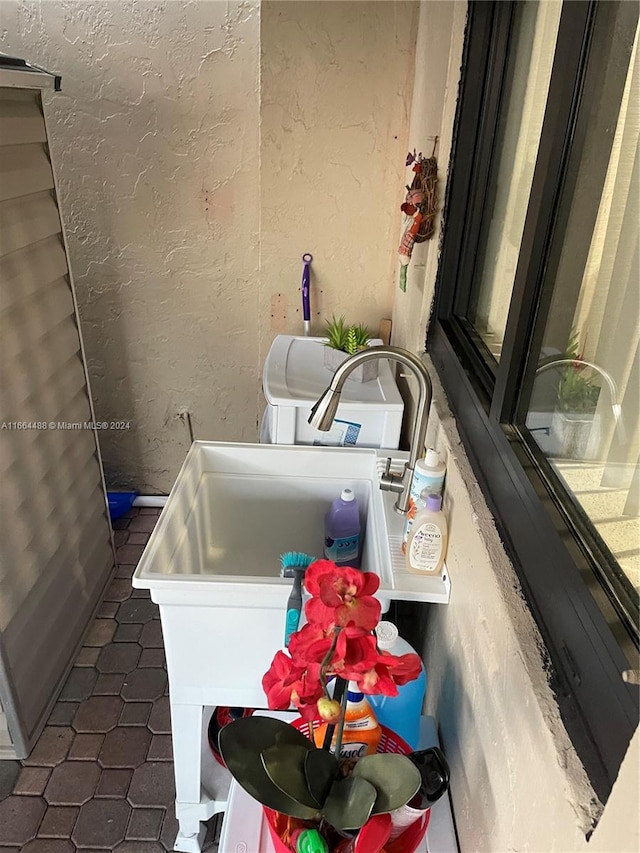 laundry area with dark tile patterned floors