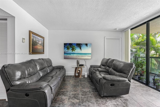 living room featuring floor to ceiling windows and a textured ceiling