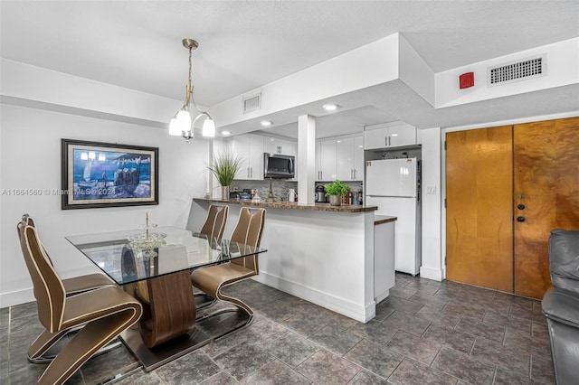 dining area featuring a textured ceiling