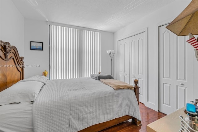 bedroom with a textured ceiling and hardwood / wood-style floors