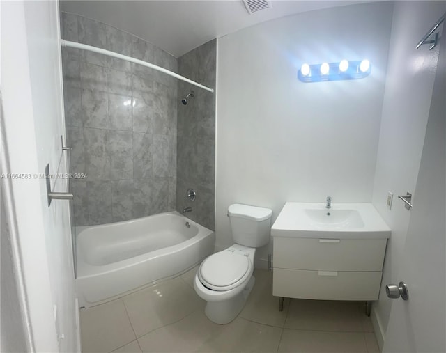 full bathroom featuring vanity, toilet, tile patterned flooring, and tiled shower / bath