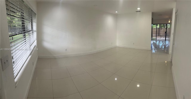 unfurnished room featuring ceiling fan and light tile patterned floors