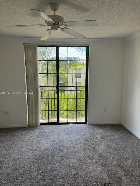 empty room featuring baseboards, carpet, a textured ceiling, and ceiling fan