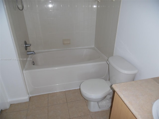 full bathroom with tile patterned floors, tiled shower / bath combo, vanity, and toilet