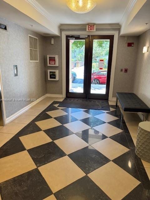 doorway to outside featuring crown molding and french doors