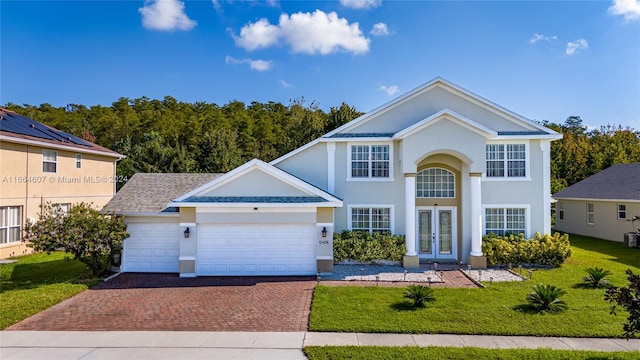 view of front of home with a garage and a front yard